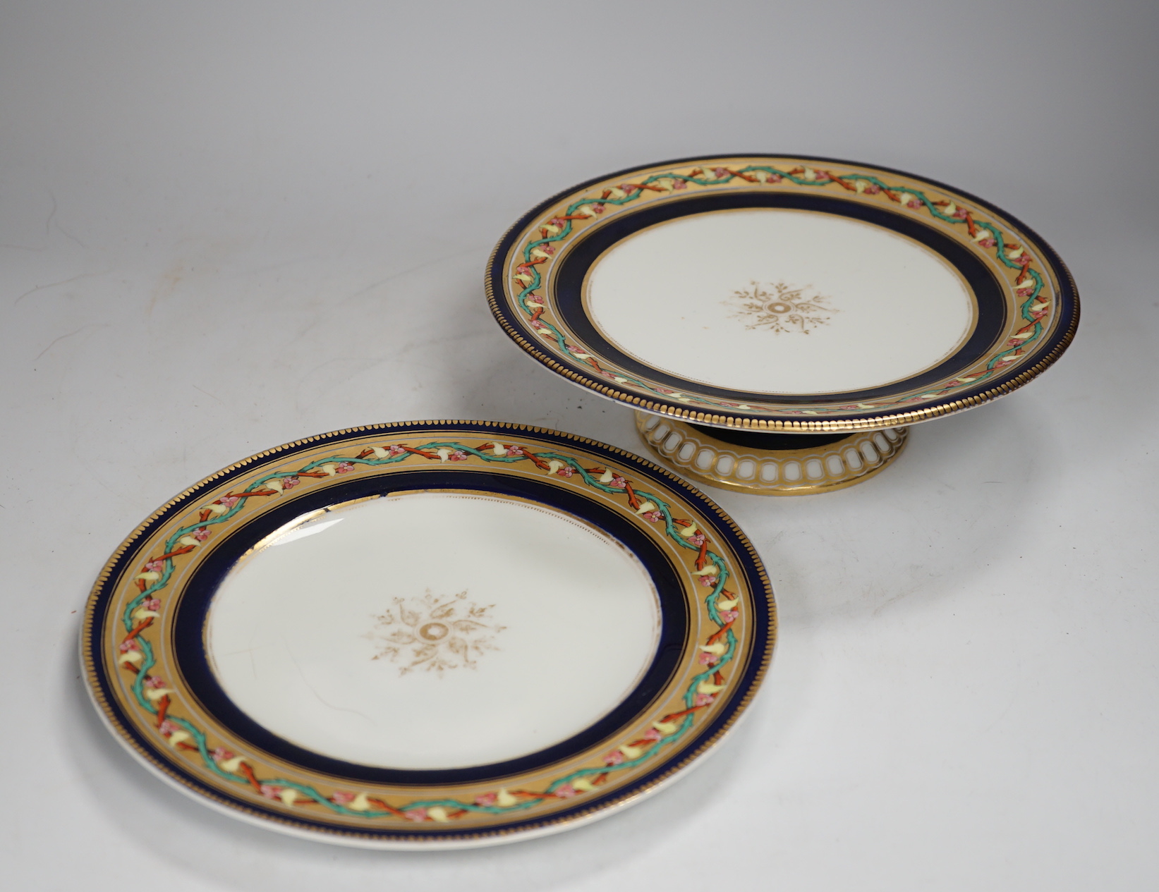 A Victorian bone china dessert service comprising eleven plates and four pedestal dishes, 23cm in diameter